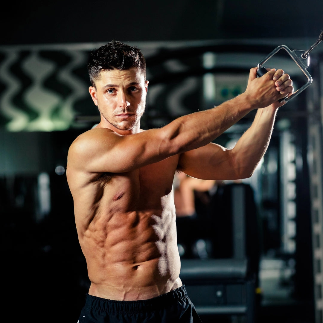 Muscular man exercising in a gym setting